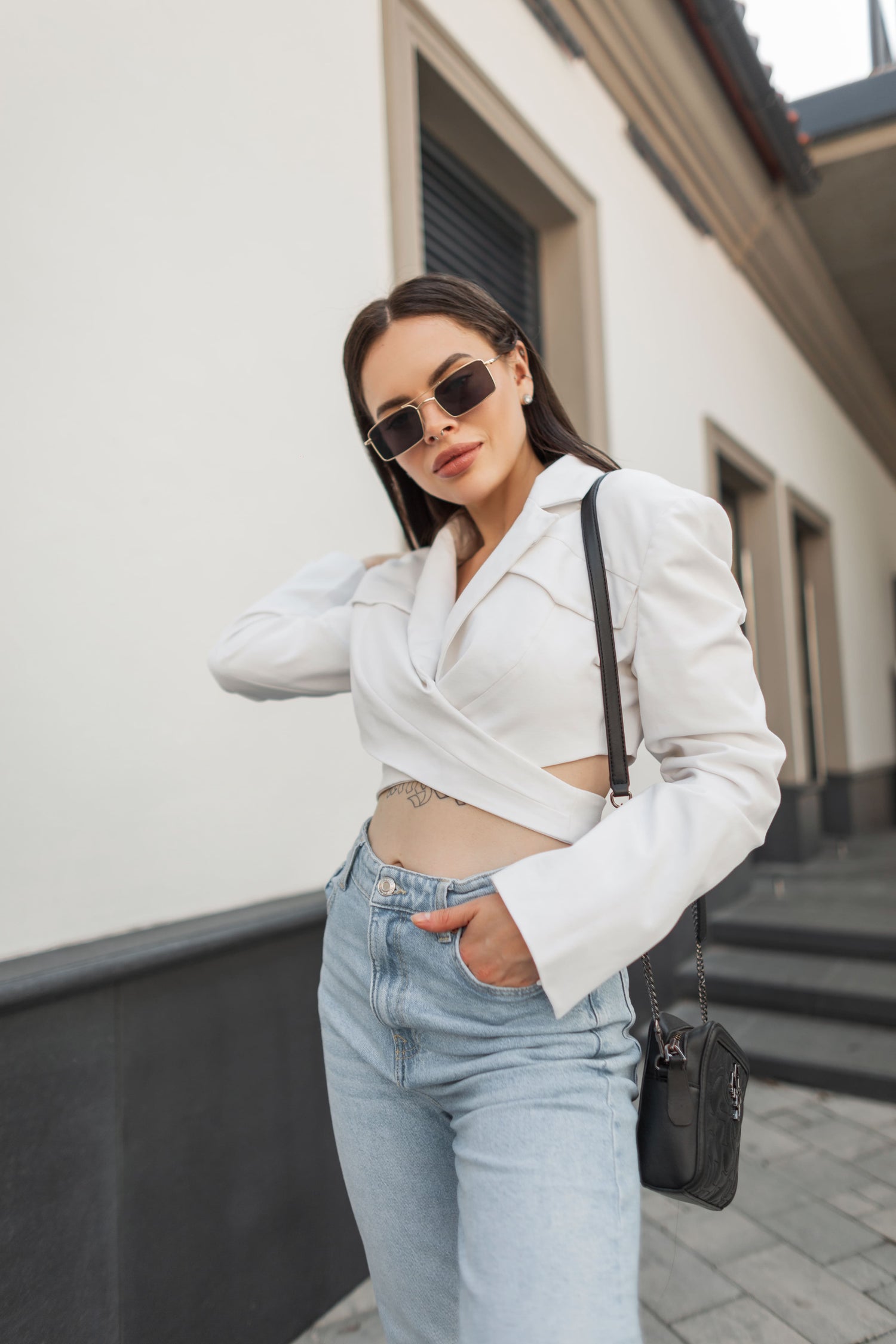 Black chain-strap crossbody bag with a compact, structured design